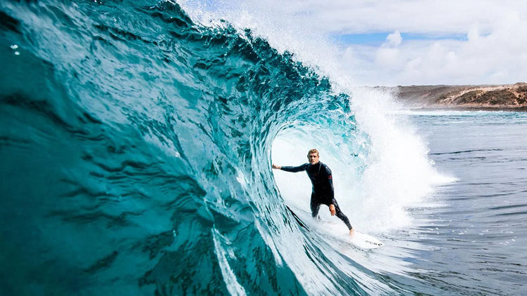Mick Fanning in the barrel of a wave while wearing the Rip Curl Flashbomb Fusion wetsuit.