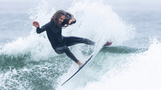 Rob Machado surfing a twin fin surfboard.