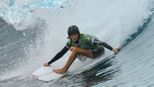 Caity Simmers getting barreled while wearing a Oakley WTR ICON surf helmet.