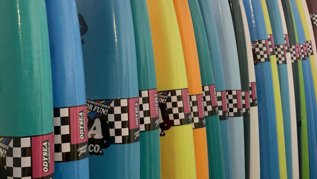 Catch Surf surfboards lined up in the surfboard rack at the Cleanline Surf shop