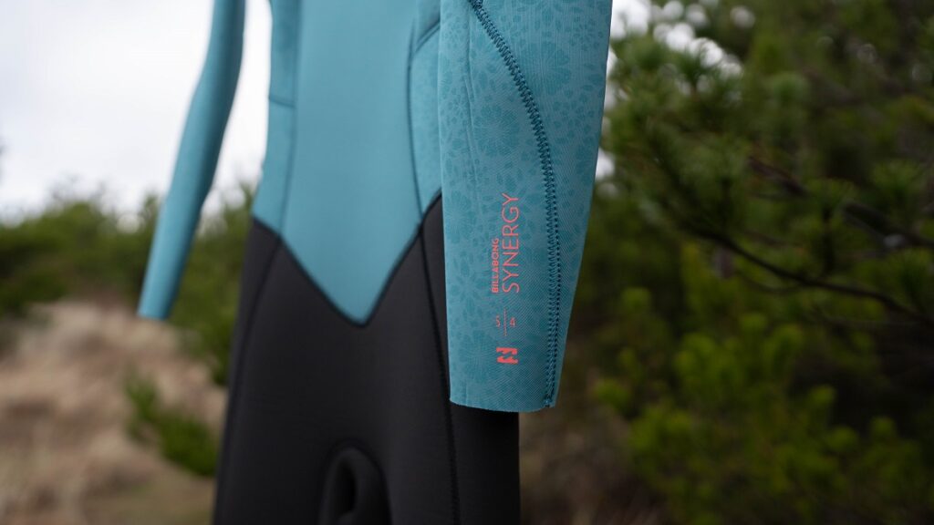 Manufacturer labeling on the left arm of the Billabong Women's Synergy wetsuit.